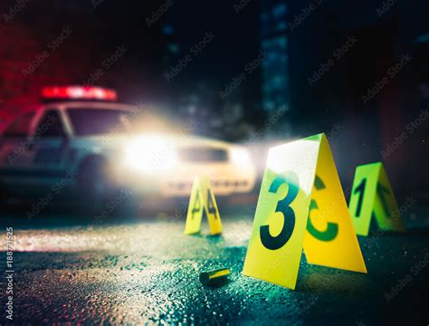 Police Car At A Crime Scene With Evidence Markers High Contrast Image