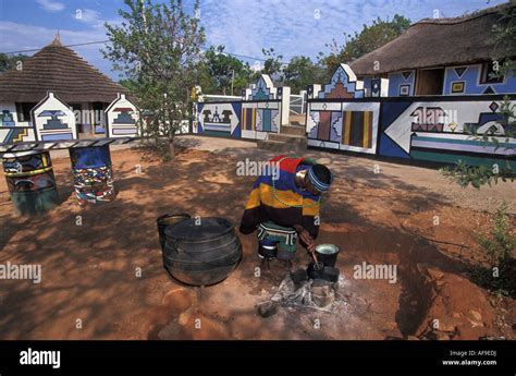 South Africa Mapoch Ndebele Village Near Pretoria Woman Cooking Houses With Traditional Wall