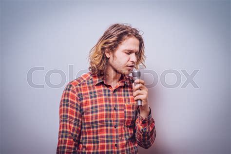 Handsome Man Singing To The Microphone Stock Image Colourbox