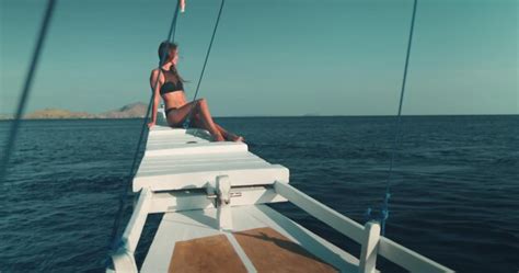 Premium Photo Woman In Bikini Sitting On Boat
