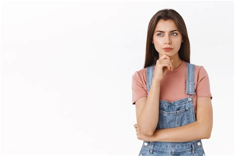 Premium Photo Suspicious Smart And Pensive Brunette Woman Smirking And Touching Chin As