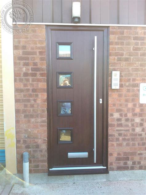 A Brown Door With Three Windows On The Side Of A Brick Building