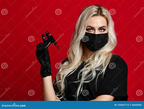 Woman Beautician Cosmetologist Hold Ear Piercing Gun In Black Medical