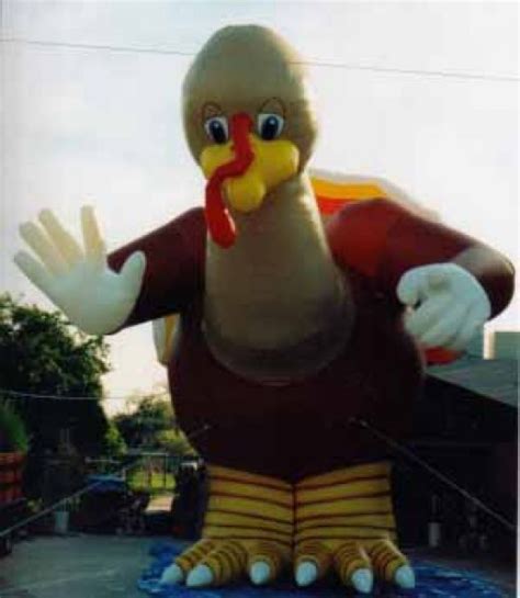 a large turkey balloon sitting on top of a parking lot