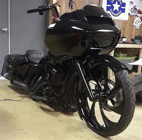 a black motorcycle parked inside of a garage