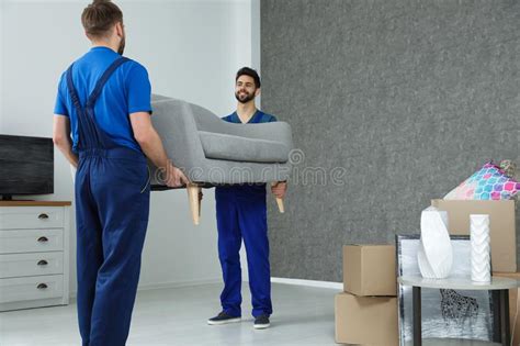 Young Workers Carrying Sofa In Room Stock Photo Image Of Adult