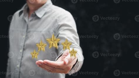 Hand Of Customer Or Client Holding The Stars To Complete Five Stars