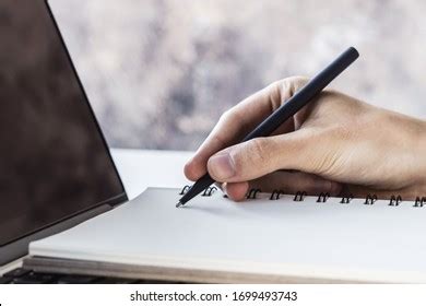 Man Writes Pen Notepad On Laptop Stock Photo 1690588657 Shutterstock