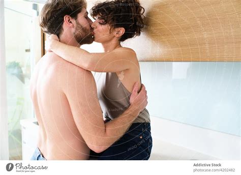 Couple Kissing In Kitchen On Counter A Royalty Free Stock Photo From