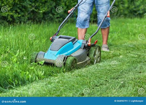 Man Cutting The Grass With A Lawn Mower Stock Image Image Of Backyard