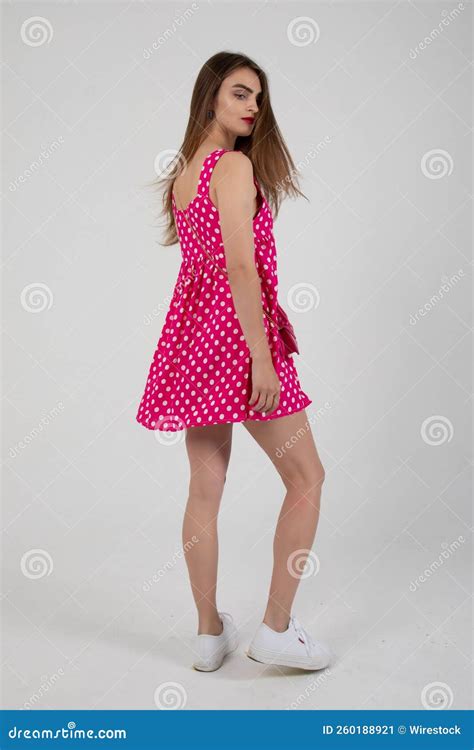 Stunning Model Posing In A Pink Polka Dot Mini Dress Stock Image