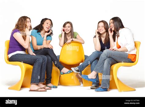 A Group Of Five Girls Having Fun And Hanging Out While Talking On The