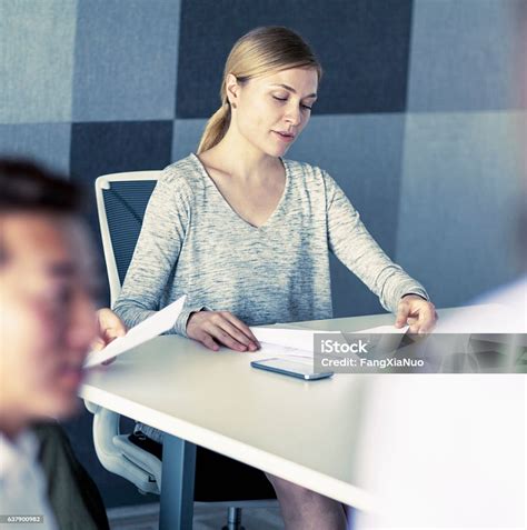 Woman Hosting Business Meeting In Conference Room Stock Photo