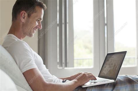 Smiling Man Using Laptop In Bed Stock Image F014 0053 Science