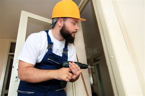 Construction Worker And Handyman Works On Renovation Of Apartment