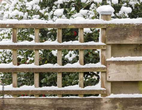 Wood fence covered in snow Stock Photo | Adobe Stock