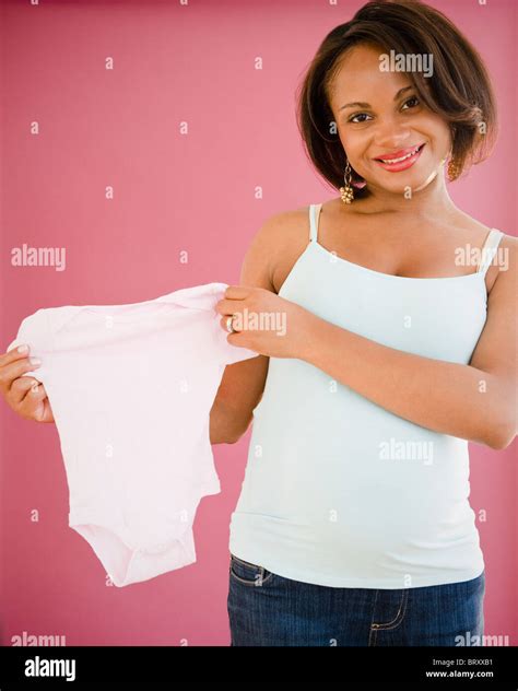 Smiling Pregnant Black Woman Holding Onesie Stock Photo Alamy