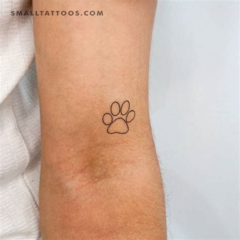 Fine Line Paw Print Temporary Tattoo Located On The