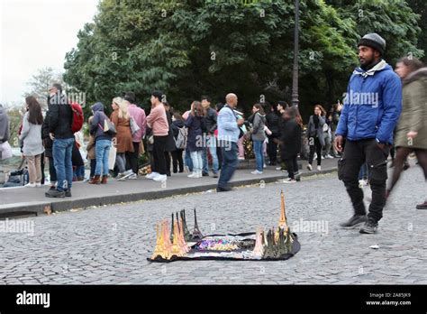 African Origin Man Selling Souvenir Eiffel Towers In Paris France Stock