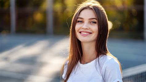 Smiley Grey Eyes Girl Model Is Standing In Blur Bokeh Background Wearing White Dress Hd Girls