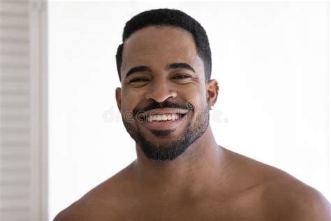 Headshot Portrait Of Smiling Biracial Man Posing In Bathroom Stock