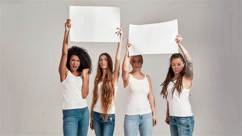 Four Diverse Women Looking At Camera While Holding Standing With Blank Banners In Their Hands