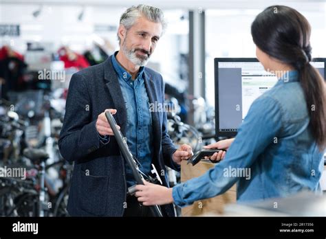Mature Man Purchasing Bicycle Wheel Stock Photo Alamy