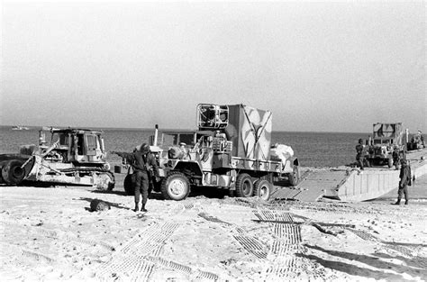 A Member Of Amphibious Construction Battalion 2 Directs The Movement Of