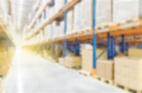 Soft blurred industrial warehouse background, with shelving and shelves ...