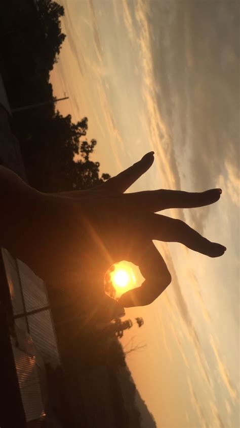 Sunset Behind Silhouette Hands