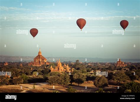 Hot Air Balloons Flying At Sunrise Over Ancient Buddhist Temples At Bagan Myanmar Burma