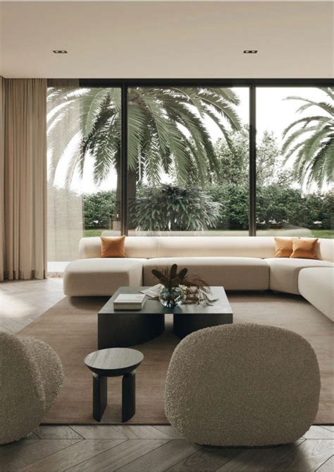 A Living Room With Couches Chairs And Tables In Front Of Large Glass