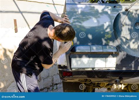 Shot Of A Man Washing His Car Under High Pressure Water Outdoors Stock