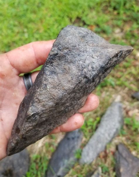 A Person Holding A Rock In Their Hand