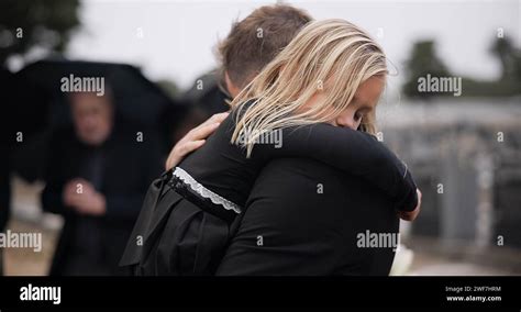 Sad, death and a girl with her father at a funeral for grief or mourning loss together outdoor ...