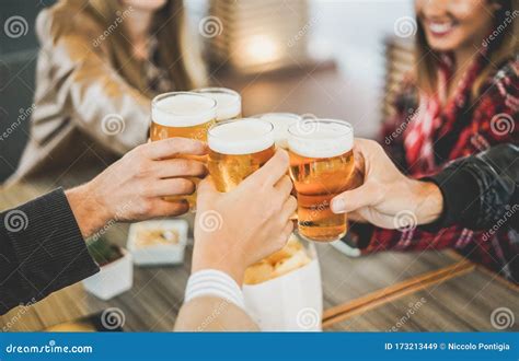 Group Of Friends Enjoying A Beer In Brewery Vintage Pub Young People