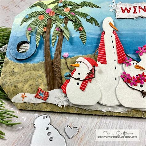 Two Snowmen Sitting Next To Each Other In Front Of A Palm Tree And Sign