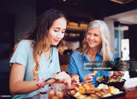 Beautiful Senior Mother And Daughter Eating Lunch Together At