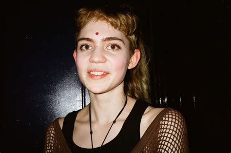 A Young Woman Wearing A Black Shirt And Red Nose Ring Posing For The