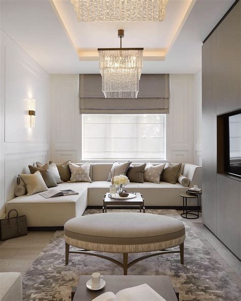 A Living Room Filled With Furniture And A Chandelier Hanging Over The