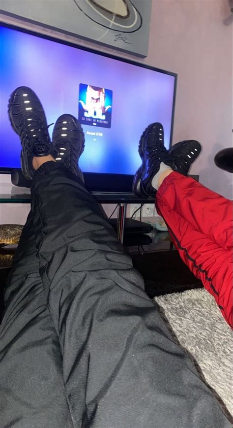 A Person With Their Feet Up In Front Of A Flat Screen Tv