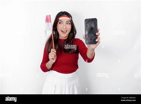 A Happy Asian Woman Wearing Headband Holding Her Phone And Indonesian