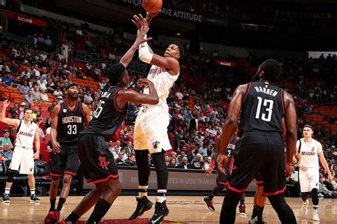 A Group Of Men Playing Basketball Against Each Other