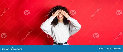 Happy Beautiful Woman With Curly Hair And Red Lips Covering Eyes With