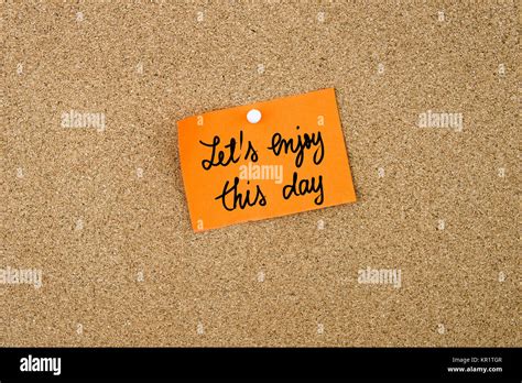 Lets Enjoy This Day Written On Orange Paper Note Stock Photo Alamy