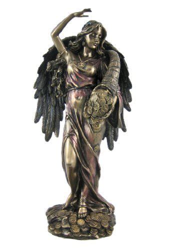 A Statue Of An Angel Holding A Shield With Her Arm Raised In Front Of