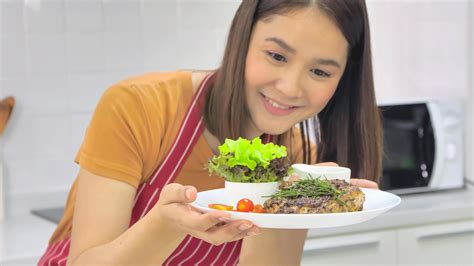 Young Asian woman cooking in kitchen at home. 11271648 Stock Photo at Vecteezy