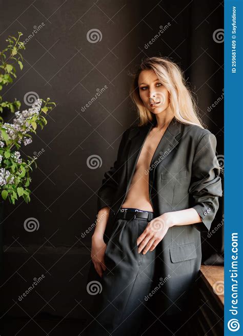 A Blonde Woman In A Black Jacket On A Naked Body In A Dark Room Stock Image Image Of Model