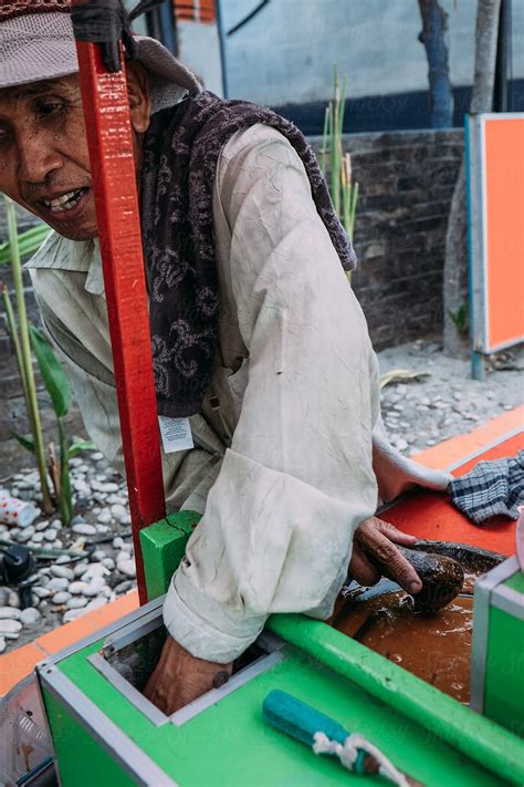 Indonesian Old Man Preparing And Selling Typical Food On The Street