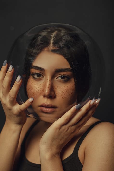 A Woman Holding Her Hands Up To Her Face Photo Free Photography Image